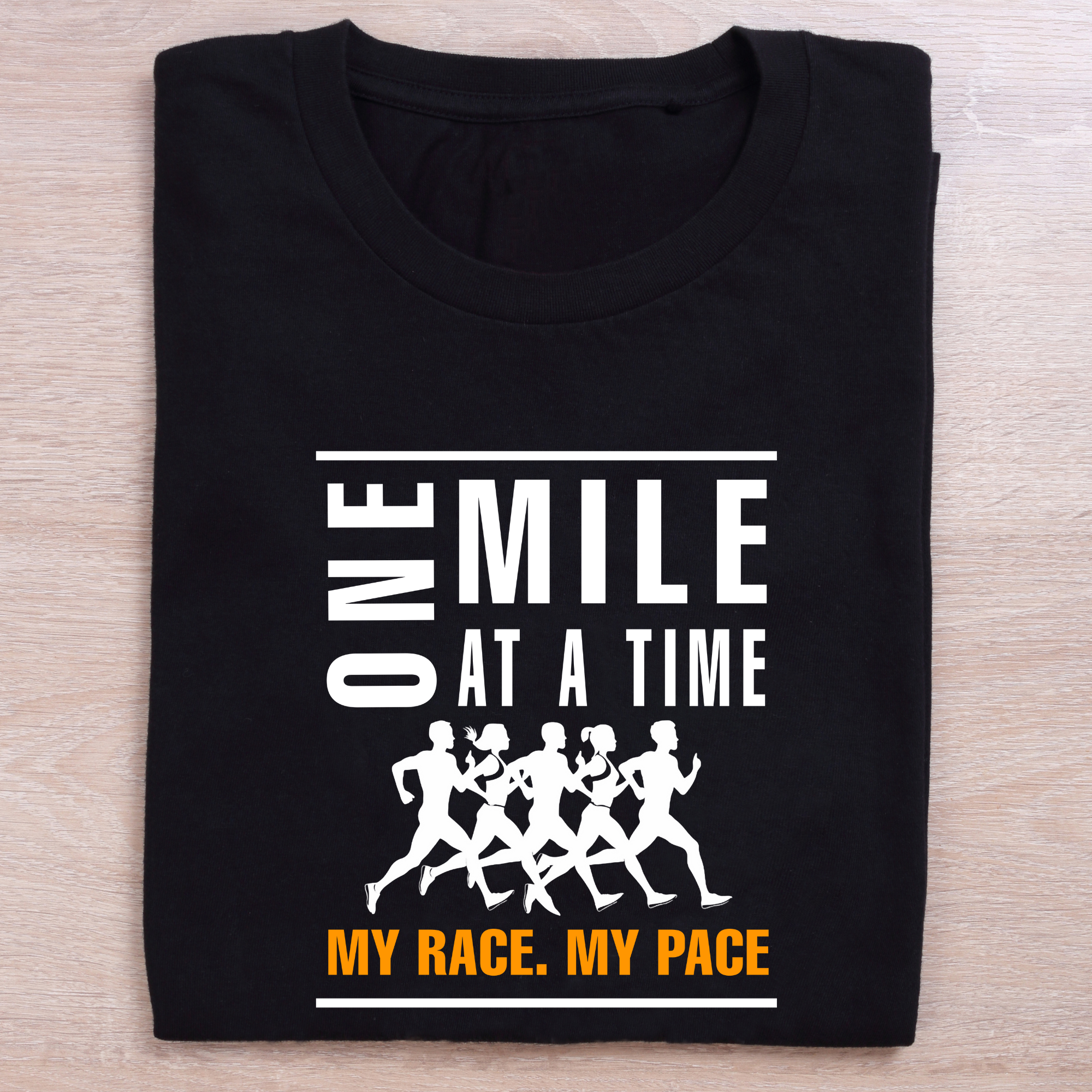 folded black running t shirt one mile at a time