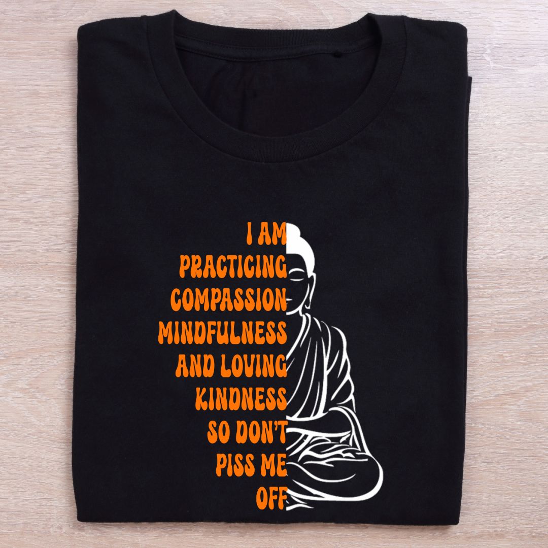 folded black yoga t shirt i am practicing compassion