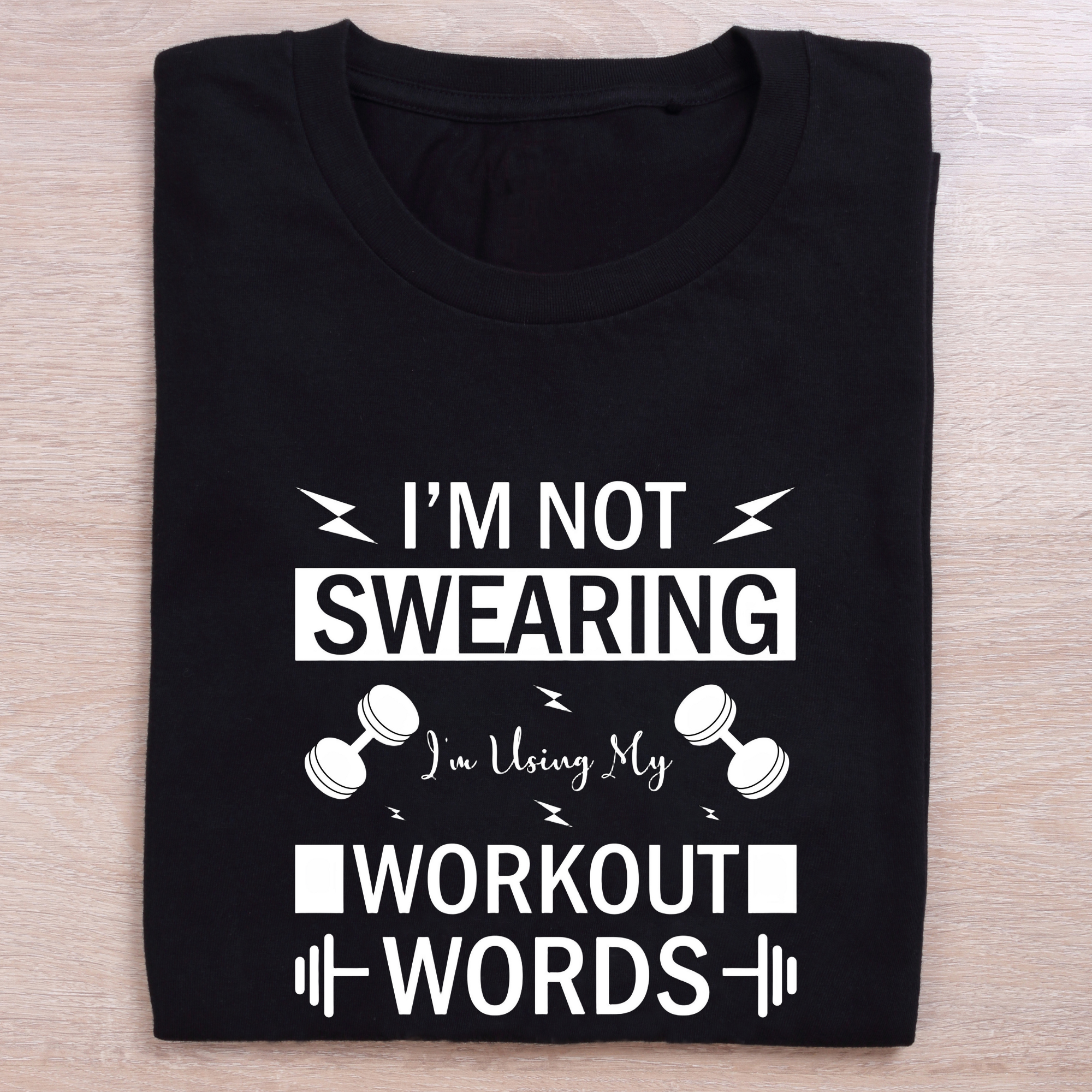 folded black gym t shirt using my workout words